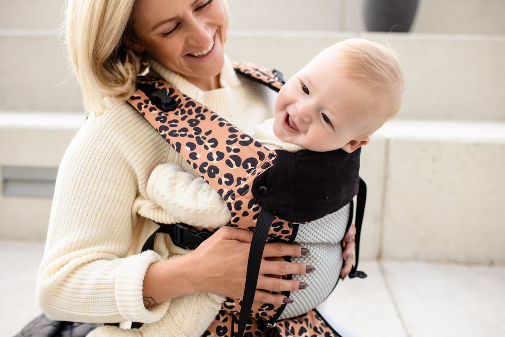 Beco 8 Baby Carrier in pink leopard with baby front carry position.