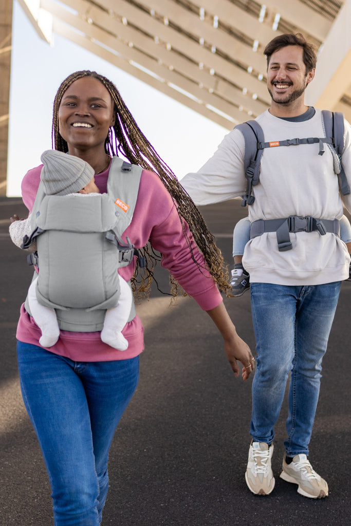 Baby front carry facing in in the Beco Gemini baby carrier in grey