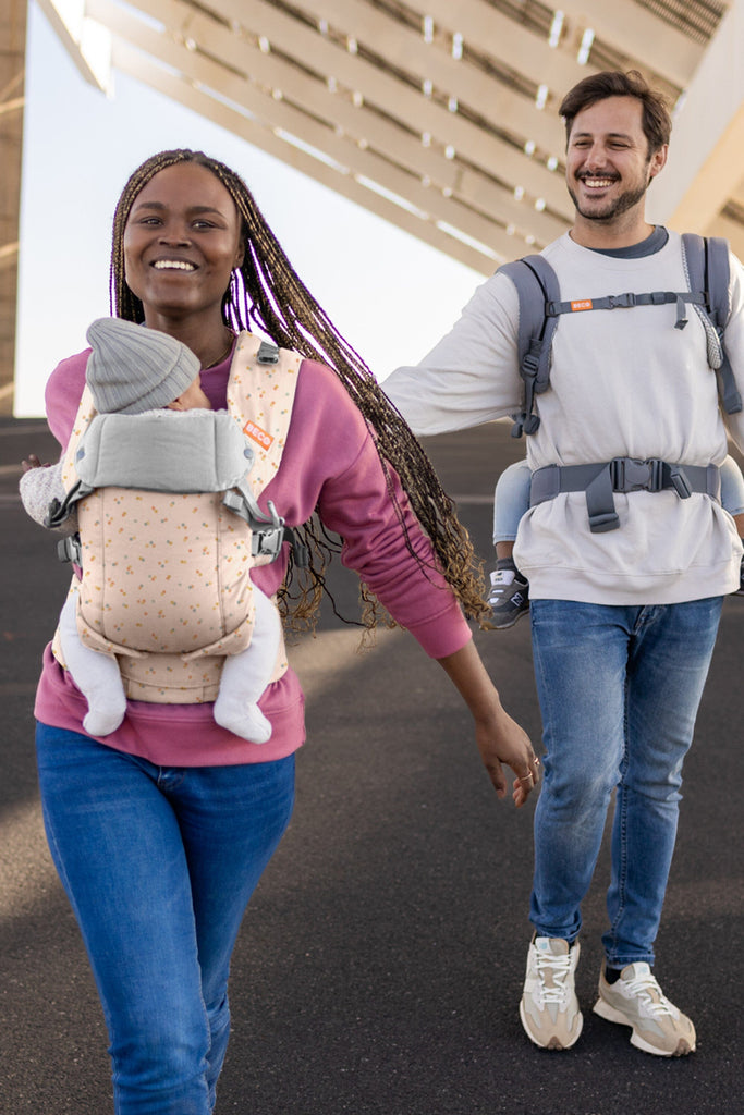 Baby front carry facing in in the Beco Gemini baby carrier in dots pattern