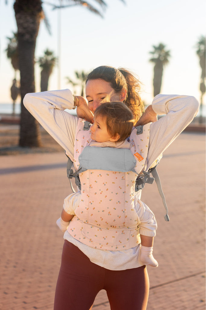 Beco Baby Carrier in Sprinkles pattern - shown with toddler in the front carry position