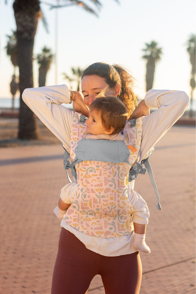 Baby front carry facing in in the Beco Gemini baby carrier in geo floral pattern