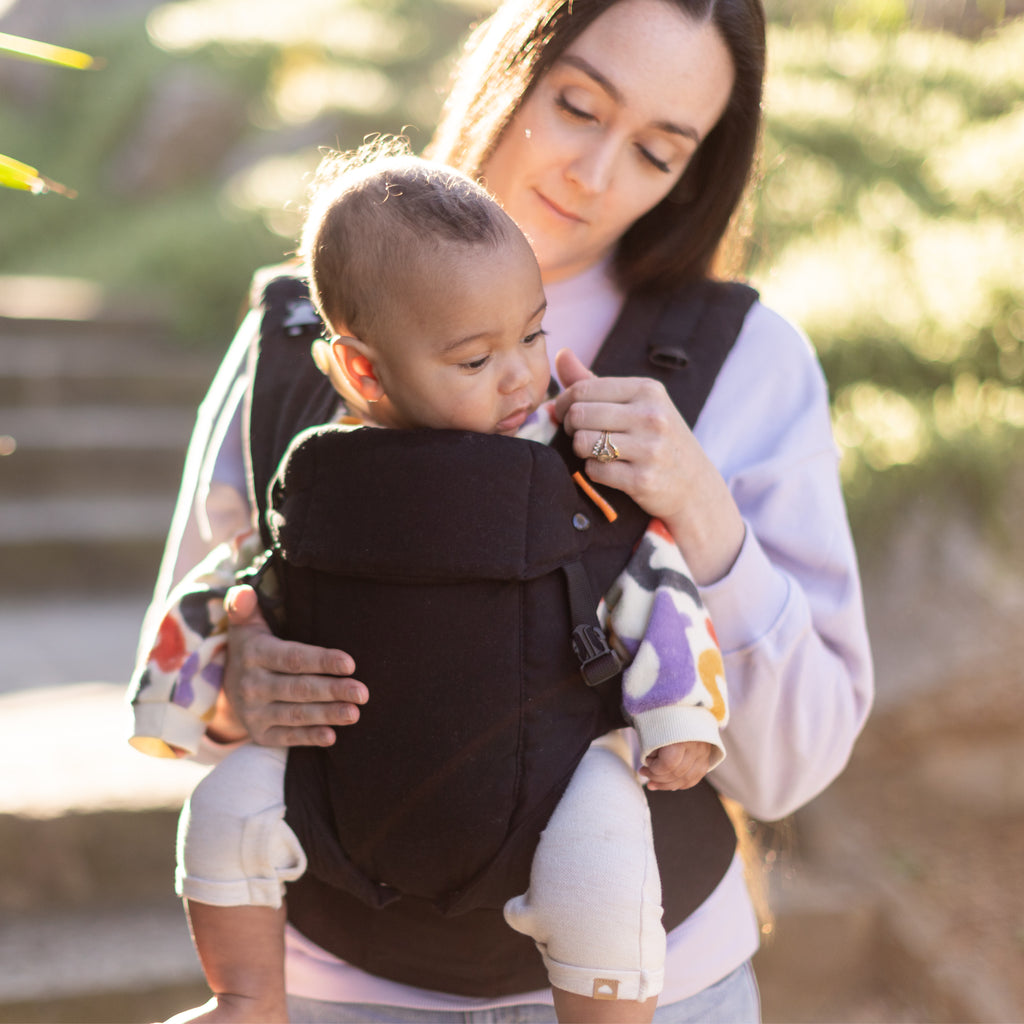 Baby in a black Beco Baby carrier