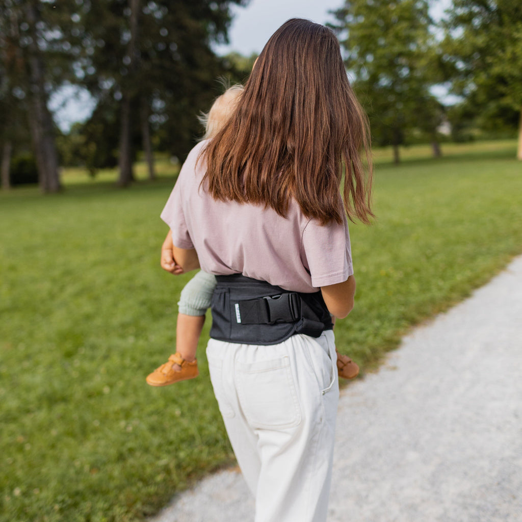 Beco Gemini Hip Seat Baby Carrier in black, ergonomic design for newborns to toddlers, featuring 4 carry positions and even weight distribution for all-day comfort.