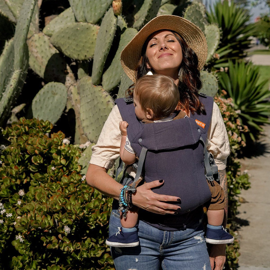 Baby in front carry in the Beco Gemini Baby Carrier in Blue Linen