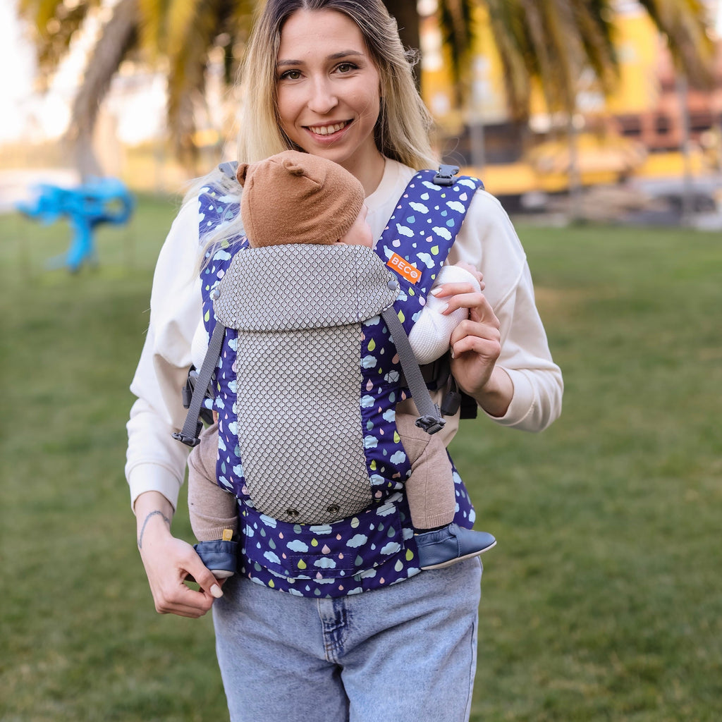 Baby in the Beco Gemini Cool Mesh Baby Carrier in Rain Drops pattern
