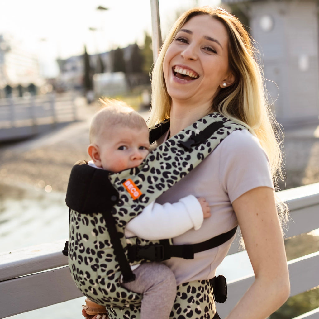 Baby front carry facing in in the Beco Gemini baby carrier in jade leopard pattern